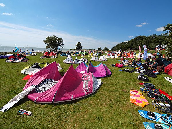 Schermen van kitesurfers vullen de weiden en de hemel bij Mirns.